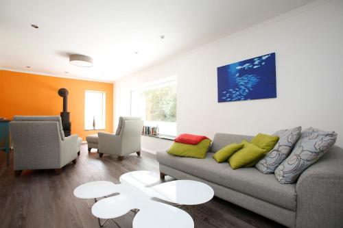 a living room with a couch and two chairs at Schönes Ferienhaus in Maasholm Bad, Ostsee in Maasholm