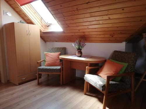 a small room with a table and two chairs at Chalupa Barborka in Stará Bystrica