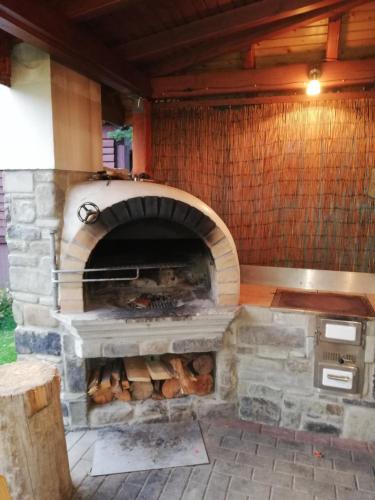 a stone oven with logs inside of it at Chalupa Barborka in Stará Bystrica
