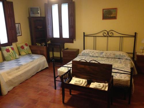 a bedroom with a bed and a chair with towels at Agriturismo La Marletta in Imola