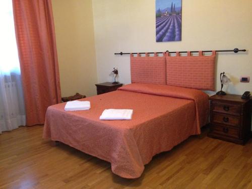 a bedroom with a bed with two towels on it at Airone Pisa Park Hotel in Pisa