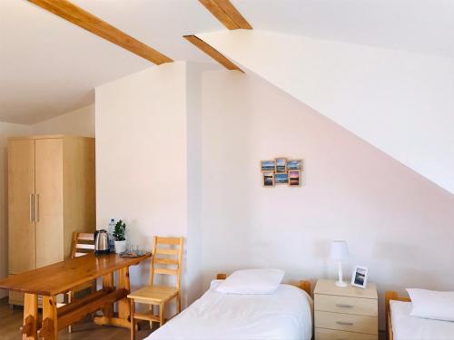 a bedroom with a desk and a bed and a table at Marina Niedźwiedzi Róg in Ruciane-Nida