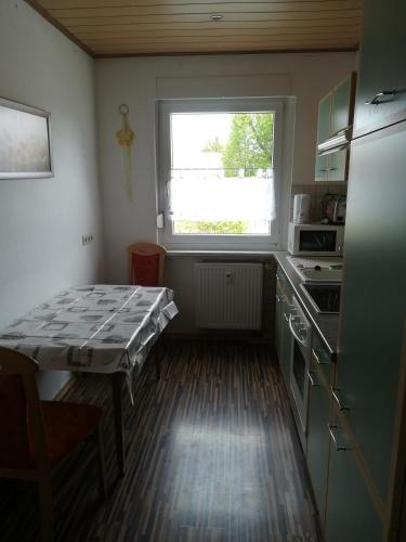 a small kitchen with a table and a window at Ländliche Erholung 3 in Heideland