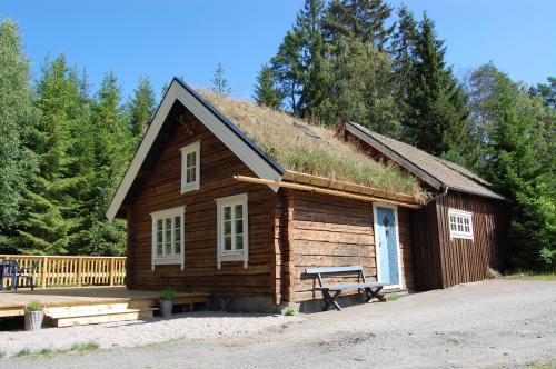 a small log cabin with a grass roof at Lillstugan in Torestorp