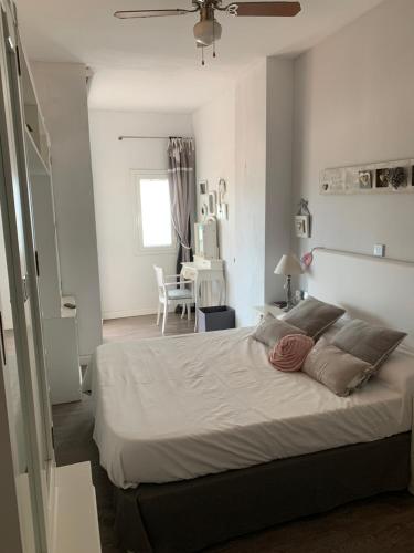 a bedroom with a large bed and a dining room at Apartamento primera línea de playa in Port Saplaya