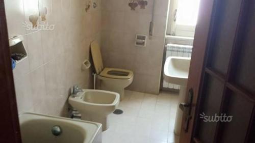 a small bathroom with a toilet and a sink at ROOM in Capua