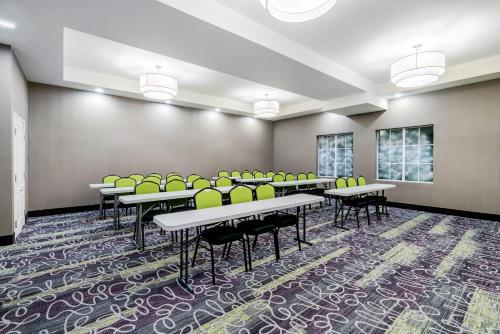 a classroom with tables and chairs in a room at La Quinta by Wyndham DFW Airport West - Bedford in Bedford