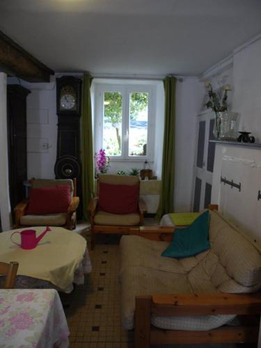 a living room with a couch and a window at les Miquelots in Pont-d'Ouilly