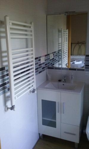 a white bathroom with a sink and a mirror at Hosteria Calixtino in Palas de Rei