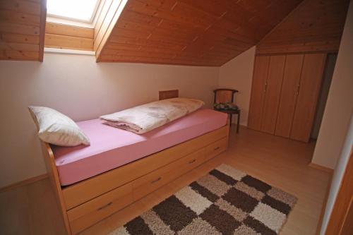 a bed in a small room with a window at Ferienwohnung Ramstein in Ramstein-Miesenbach