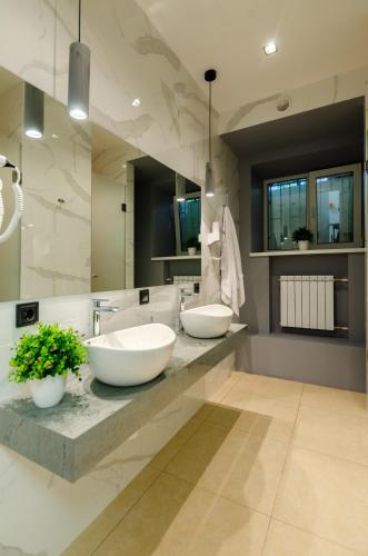 a bathroom with two sinks and a large mirror at Underground Hostel in Kyiv