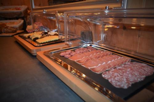 a display case with different types of meats and cheese at Gasthaus Alpina in Tschappina