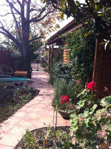 a garden with a pathway and flowers and a bench at Klein Hospitality in the Galilee Hagoshrim in Hagoshrim