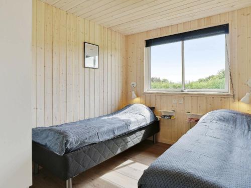 a bedroom with two beds and a window at 20 person holiday home in Nørre Nebel in Nørre Nebel