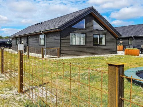 a house with a fence in front of it at 20 person holiday home in Nørre Nebel in Nørre Nebel