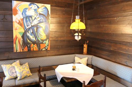 a dining room with a table and a painting on the wall at Hotel Alpenhof Postillion in Kochel