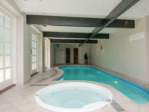 a large swimming pool with a large tub in a room at 10 person holiday home in Bramming in Bramming