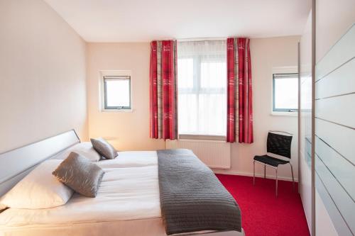 A bed or beds in a room at Appartement Spoorklokken