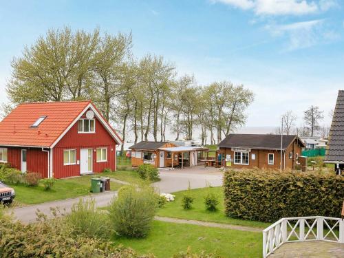 a house with a red roof in a village at 8 person holiday home in Gelting in Gelting