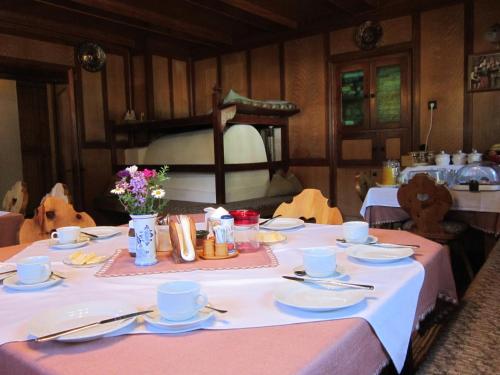 a table with a white table cloth on it at Hansenhof in Prägraten am Großvenediger