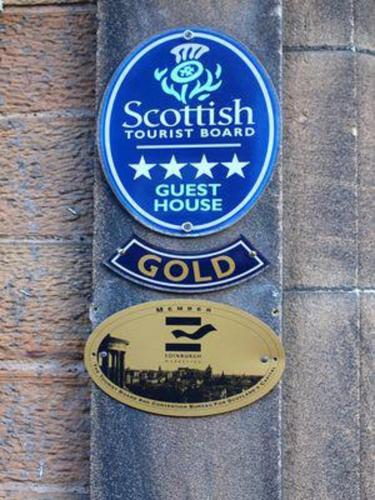 a sign for the scottish tourist board on a wall at Highfield Guest House in Edinburgh