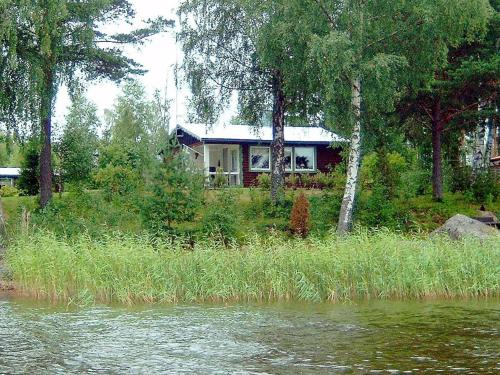 una casa sentada a orillas de un río en 4 person holiday home in STORFORS, en Storfors