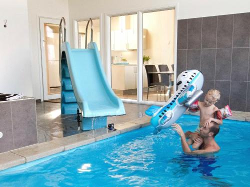 twee jonge mannen spelen in een zwembad bij 14 person holiday home in Sydals in Høruphav