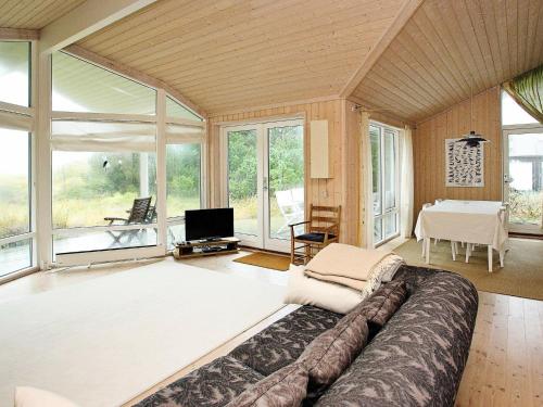 JerupにあるThree-Bedroom Holiday home in Jerup 8の広いリビングルーム(ソファ、テーブル付)