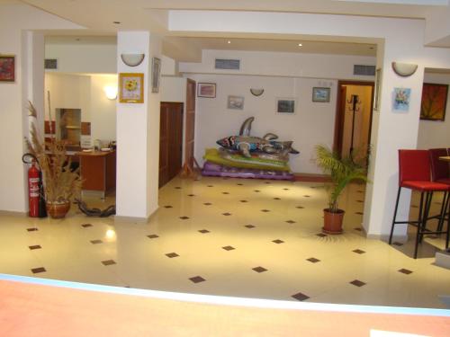 a living room with a tile floor and a room at Hotel Bellisimo in Lozenets