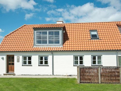 een wit huis met een oranje dak bij 6 person holiday home in Hejls in Hejls