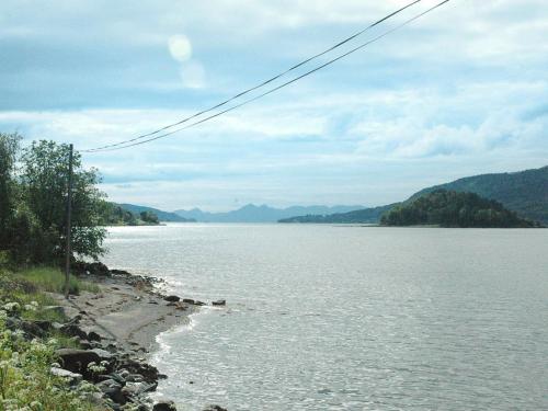 a view of a body of water with mountains at Four-Bedroom Holiday home in Åfarnes in Årset