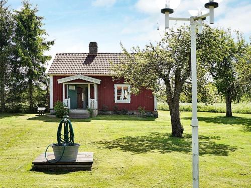 a red house with a street light in front of it at 4 person holiday home in ANKARSRUM in Hult