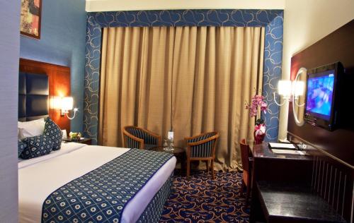 Postel nebo postele na pokoji v ubytování Ramee Rose Hotel