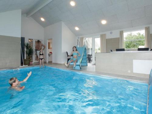 a group of people in a swimming pool at 18 person holiday home in Tisvildeleje in Tisvildeleje
