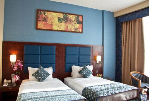 Postel nebo postele na pokoji v ubytování Ramee Rose Hotel