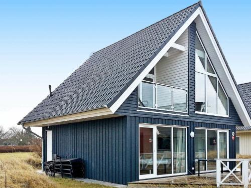 a black house with a gambrel roof at 6 person holiday home in Wendtorf in Wendtorf