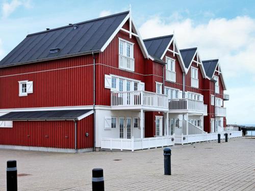 a large red barn with black roof at 6 person holiday home in Bagenkop in Bagenkop