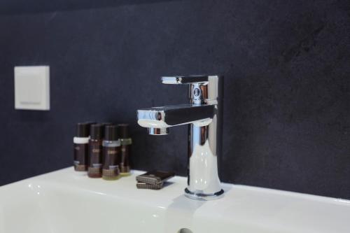 a bathroom sink with a faucet on a counter at Naturhotel Wittelsbach in Aichach