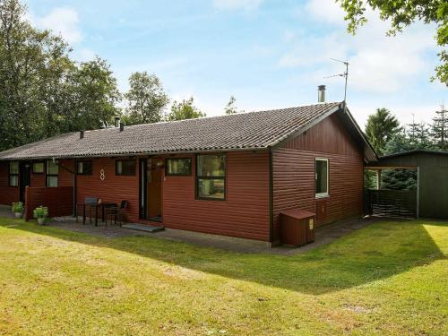 a small red house with a yard at 5 person holiday home in Silkeborg in Silkeborg