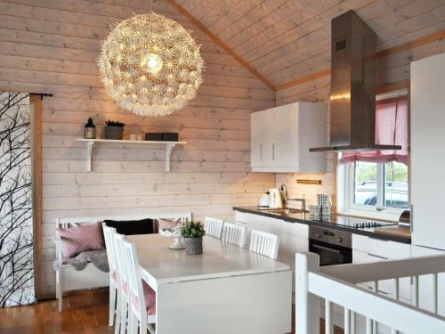 a kitchen and dining room with a table and a chandelier at Holiday home Øyer in Hafjell