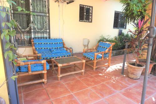 a group of chairs and tables on a patio at B & B Villa Calliandra in Bijilo