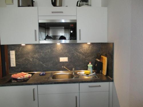 a kitchen with a sink and a counter top at Fishermans in Borkum