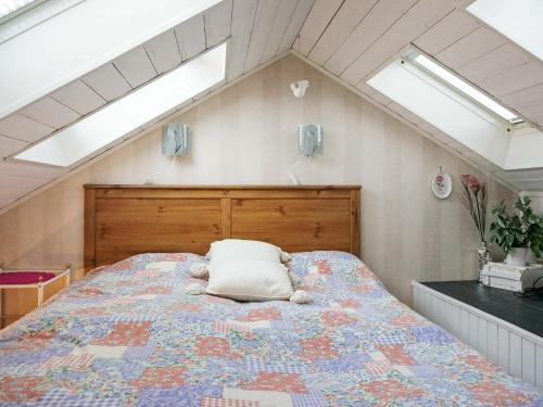 a bedroom with a bed with a pillow on it at 5 person holiday home in FALKENBERG-By Traum in Falkenberg
