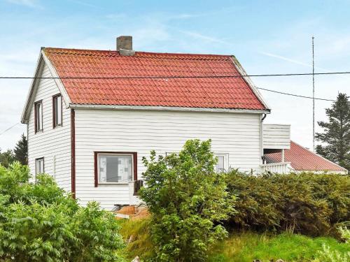 a white house with an orange roof at 6 person holiday home in Dyrvik in Dyrvik