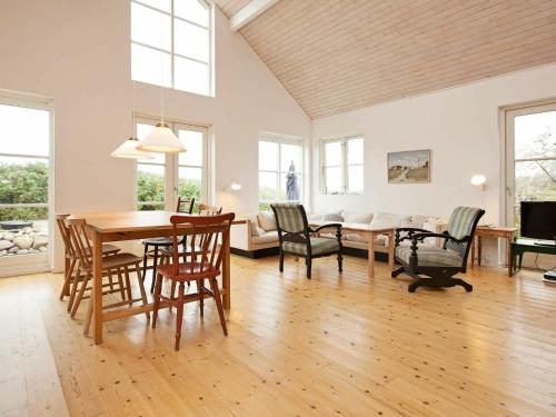 a dining room and living room with a table and chairs at 6 person holiday home in Store Fuglede in Store Fuglede