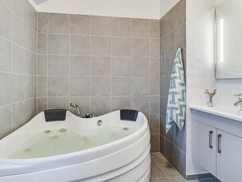 a white bath tub in a bathroom with a sink at Holiday home Kappeln XVII in Kappeln