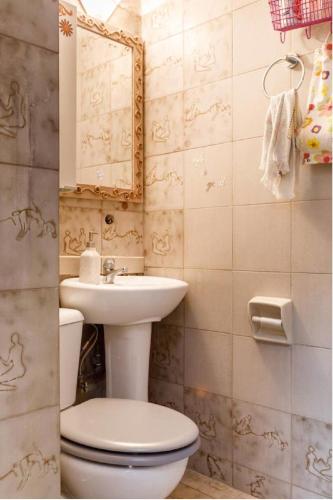 a bathroom with a toilet and a sink at 2BD- Perfect Location with square view in Thessaloniki