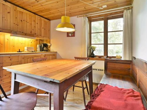 a kitchen with a wooden table in a room at 4 person holiday home in HALLABRO in Hallabro