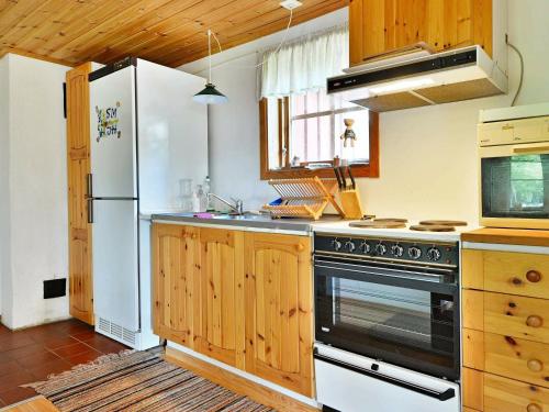 a kitchen with a stove and a refrigerator at 4 person holiday home in HALLABRO in Hallabro
