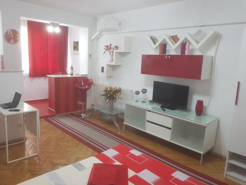 a living room with a television and red cabinets at Calea Victoriei Residence in Bucharest